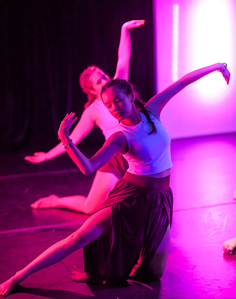 Bella dancing in pink stage light