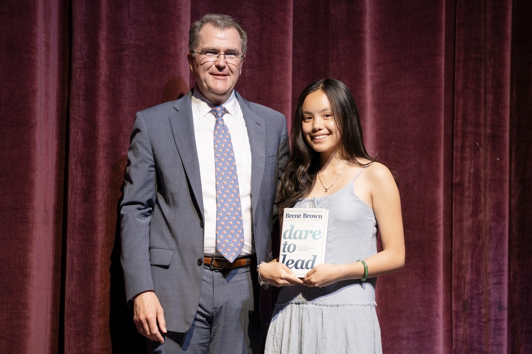 Bella on stage receiving a leadership award