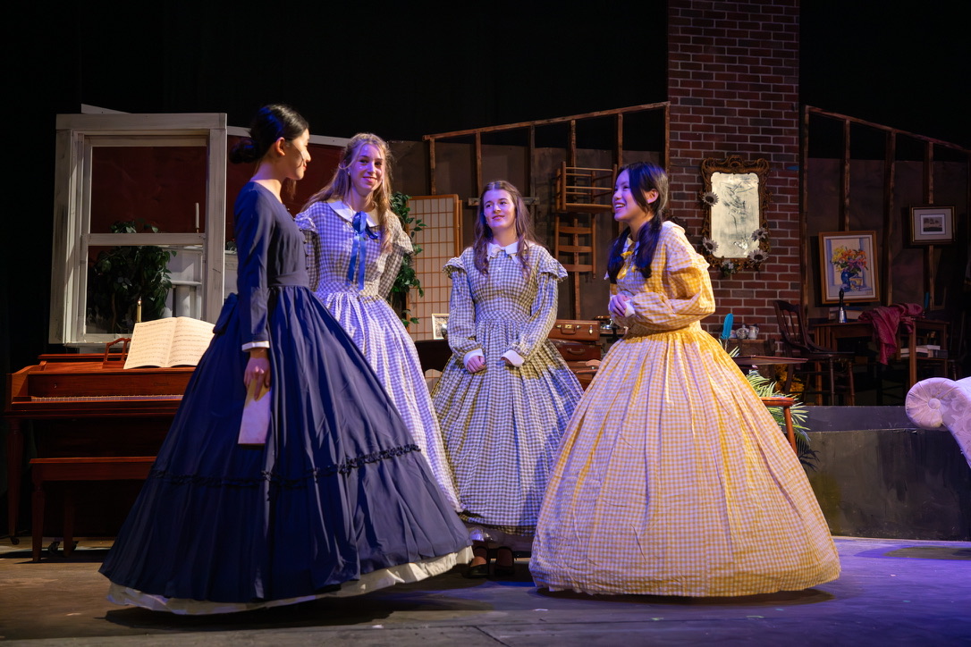 Bella in a yellow gingham dress performing in a period play