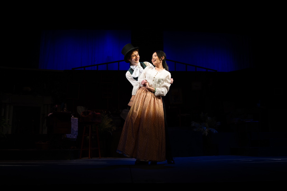 Bella in a dramatic two-person scene under blue stage light